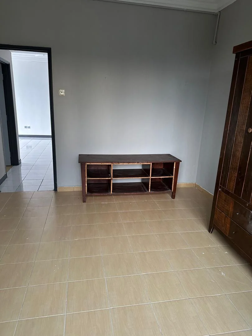 Room features: grey painted walls, tile flooring in beige, wooden console table, wooden wardrobe, doorway leading to another room.